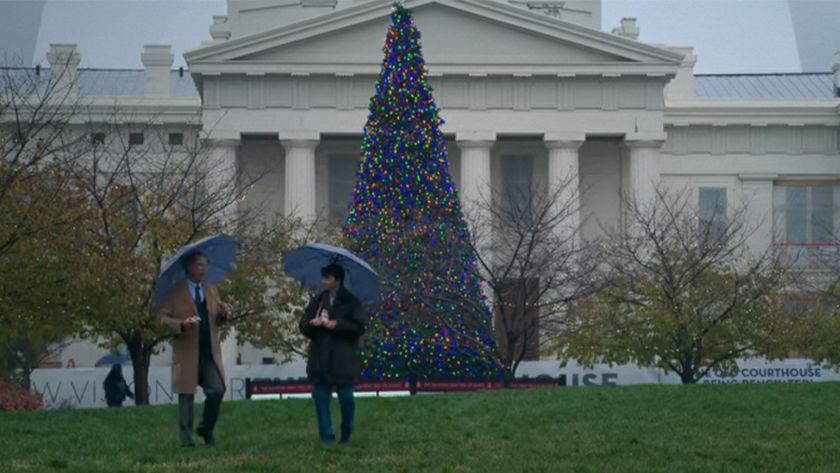 Two characters carrying umbrellas in front of the Old Courthouse in St. Louis in Soul on Fire