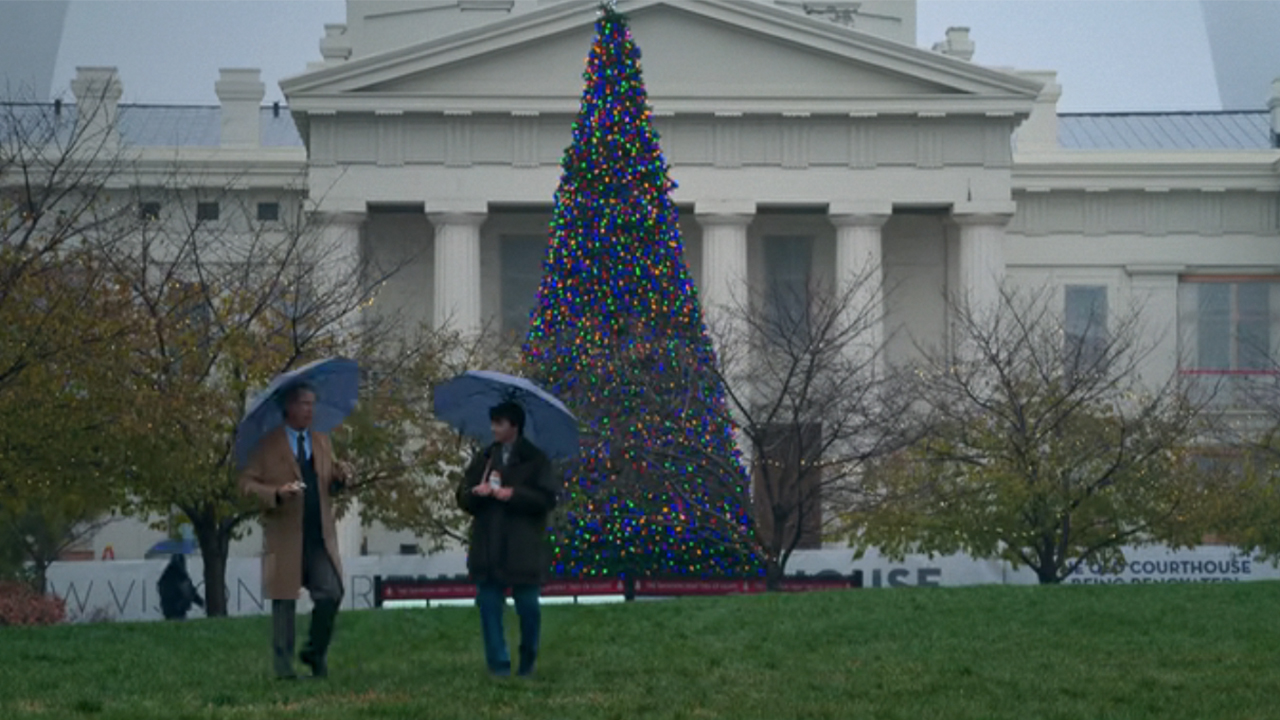 Two characters carrying umbrellas in front of the Old Courthouse in St. Louis in Soul on Fire