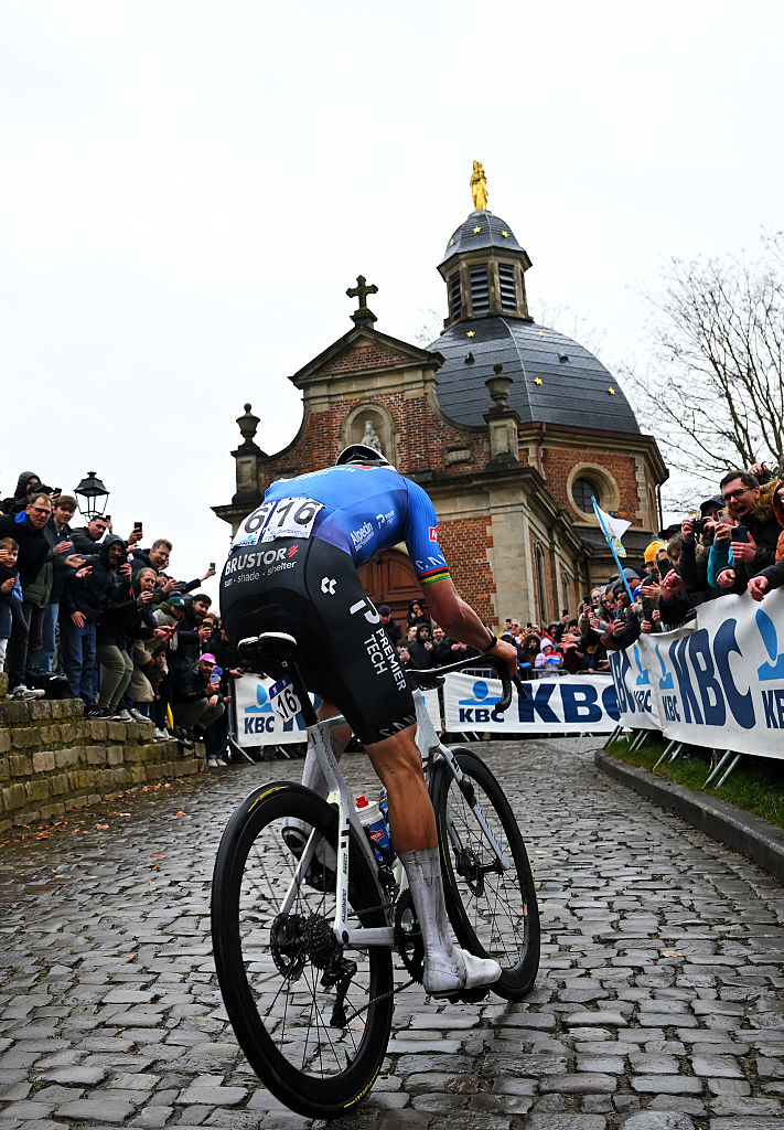 NIVONE, BELGIUM - FEBRUARY 28: Race winner Mathieu van der Poel of Netherlands and Team Alpecin-Premier Tech competes passing through the Muur - Kapelmuur cobblestones sector while fans cheer during the 21st Omloop Het Nieuwsblad 2026, Men&amp;amp;apos;s Elite a 207.2km one day race from Ghent to Ninove / #UCIWT / on February 28, 2026 in Ninove, Belgium. (Photo by Tim de Waele/Getty Images)