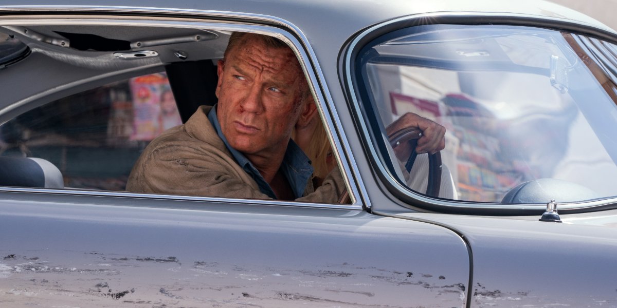 No Time To Die James Bond glares out of his car&#039;s window