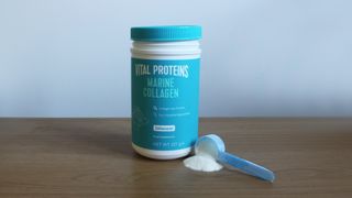 Tub of Vital Proteins Marine Collagen with some powder dispensed on a table