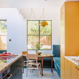 colourful kitchen with yellow cabinets and green Crittal windows