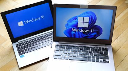 Laptop with Windows 10 logo pictured on screen alongside another laptop with Windows 11 logo on screen.