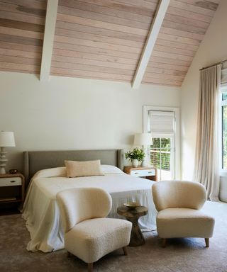 bedroom with cream walls and cream statement chairs