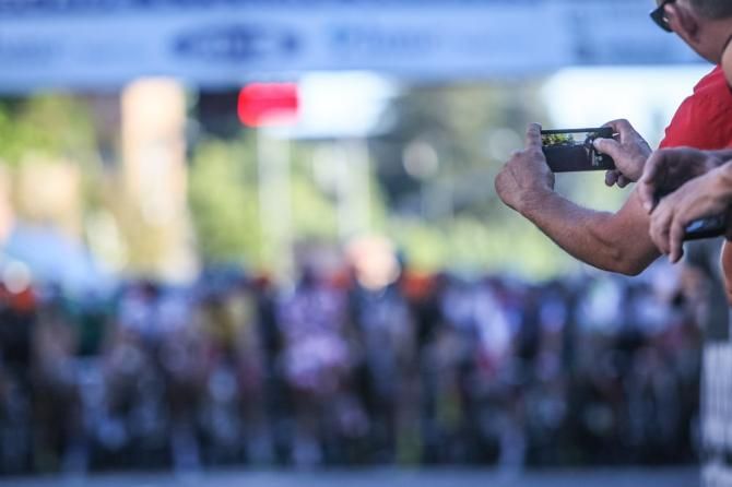 A fan gets ready to capture the race action.