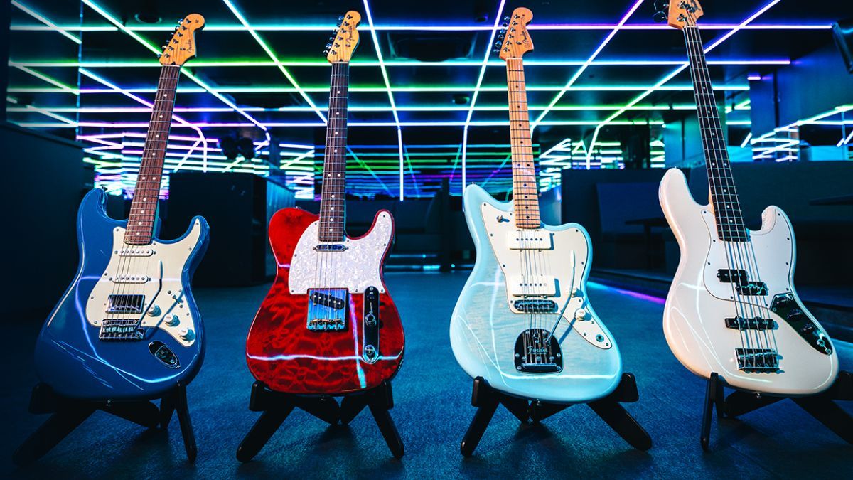 Four Fender guitars, stood against a colorful background