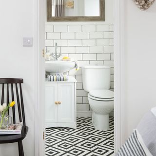 bathroom with white tiles white walls and sink