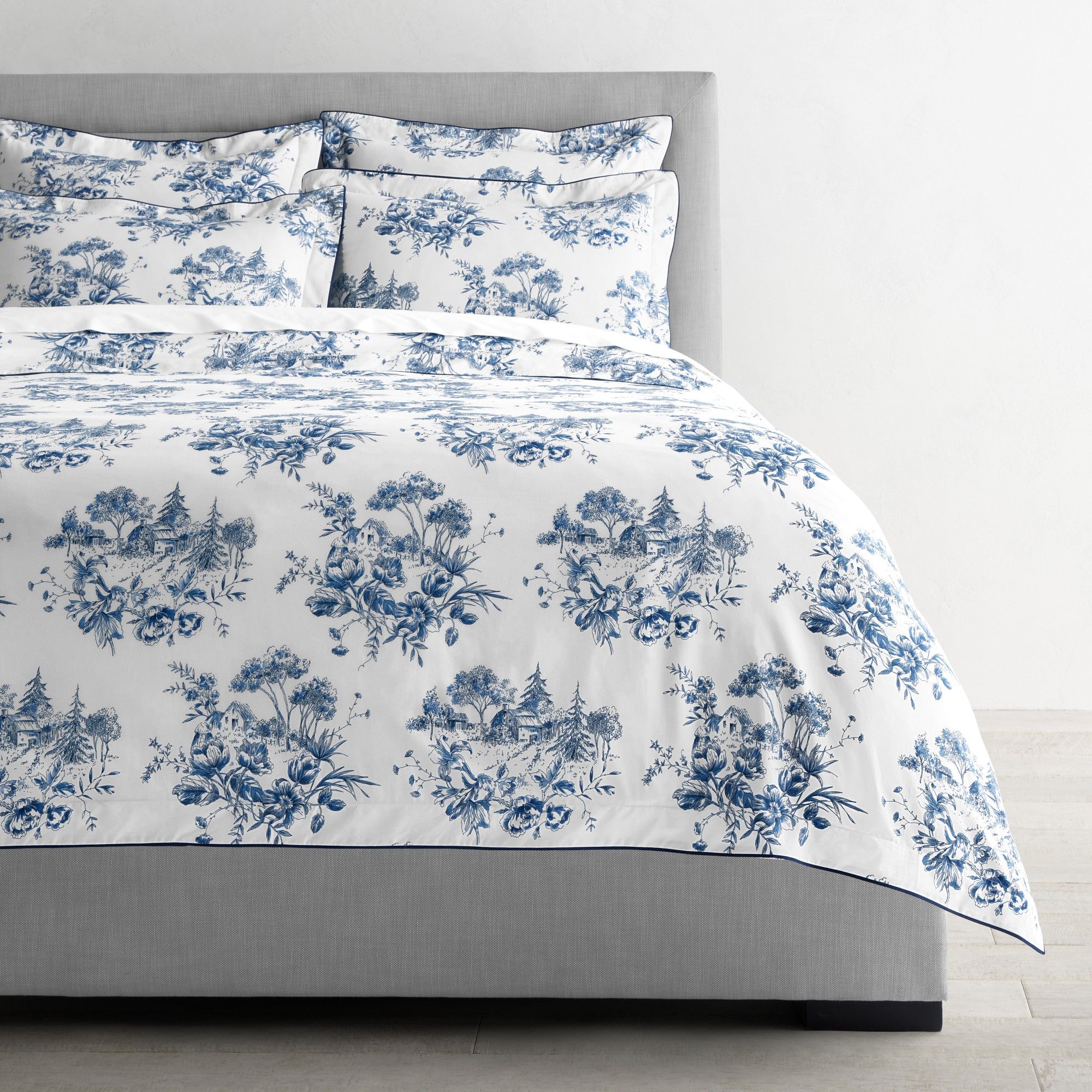 White bedding with navy floral toile motifs