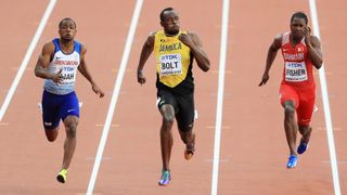 Three men sprint on a track