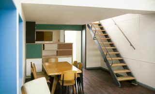 Polychrome kitchen and dining area of a two floor residential unit