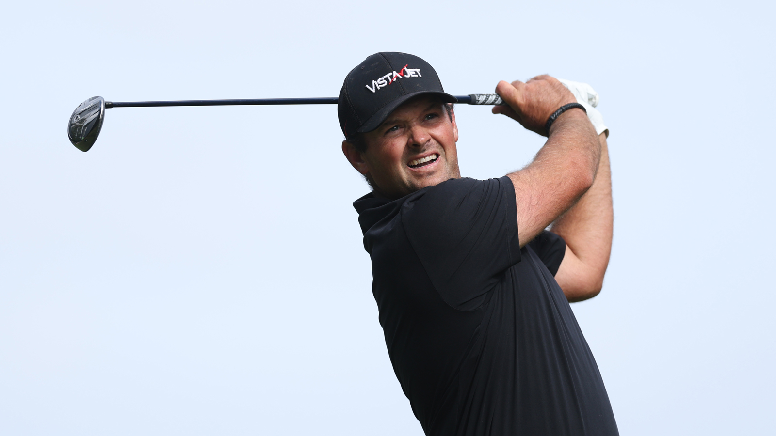 Patrick Reed hits a fairway wood