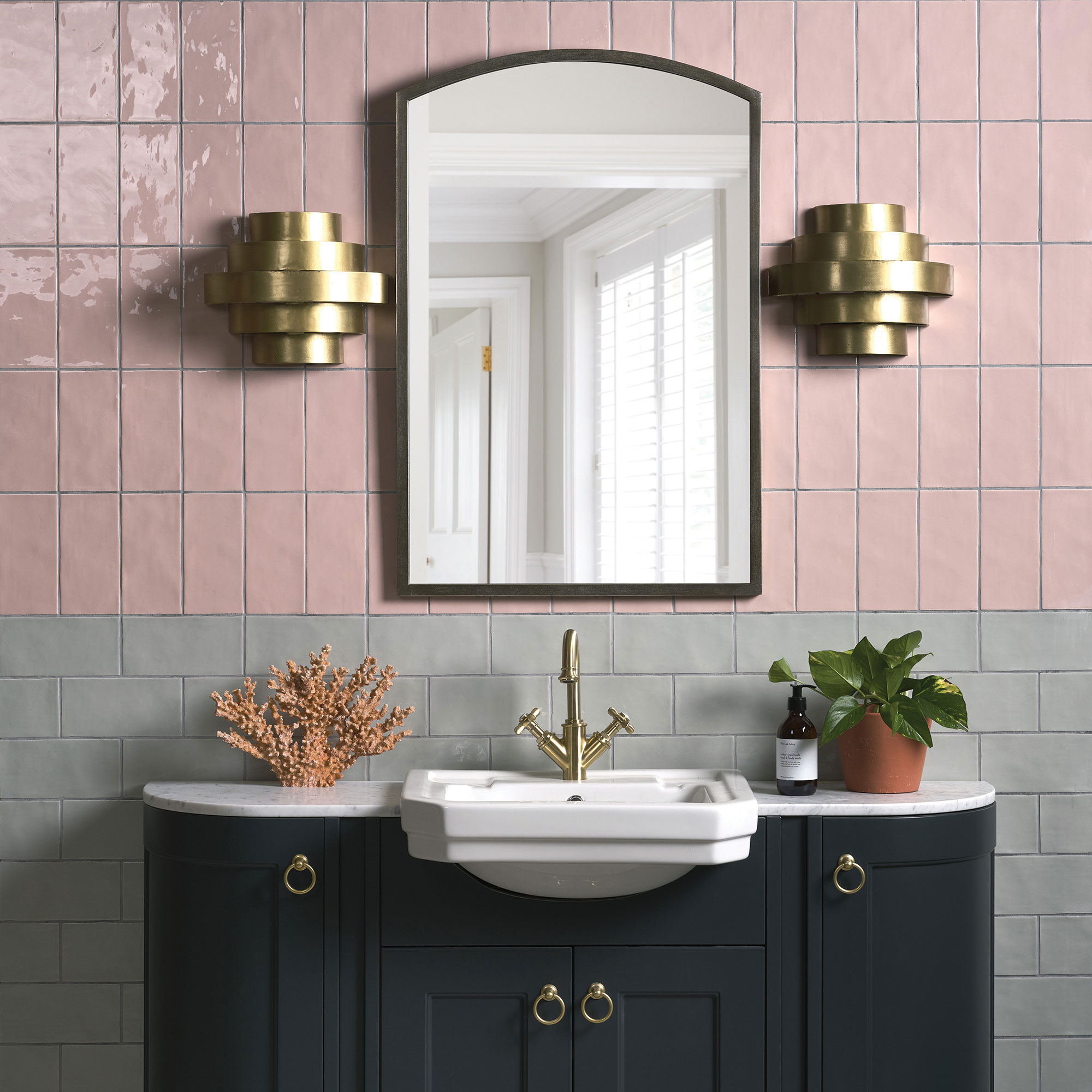 Bathroom with pink and grey wall tiled, vanity unit and mirror