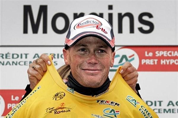 New overall leader American Christopher Horner (Predictor Lotto) smiles with his yellow jersey on the podium.