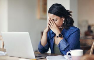 Woman working from home looking stressed
