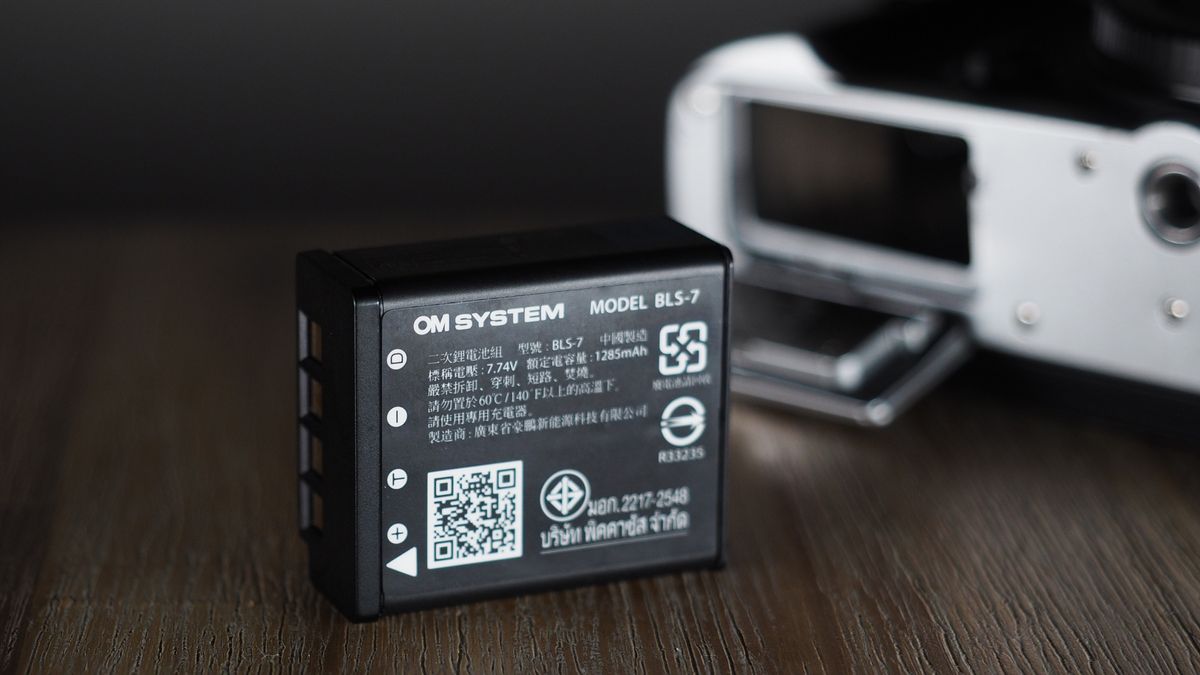 OM System OM-3 on a wooden surface