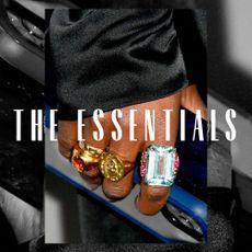 A hand wearing three chunky rings. Overlaid text reads, "The Essentials"