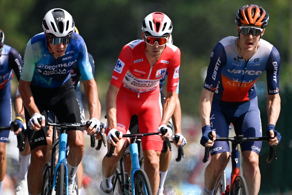 The overall ranking leader team Decathlon-AG2R La Mondiale's Ben O'Connor (C) rides with the pack during the stage 11 of the Vuelta a Espana, a 166.5 km race between Padron and Padron, on August 28, 2024. (Photo by MIGUEL RIOPA / AFP)