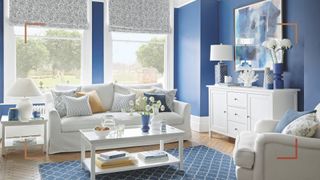 Blue living room with white furniture and large windows to support interior design tips to beat winter blues