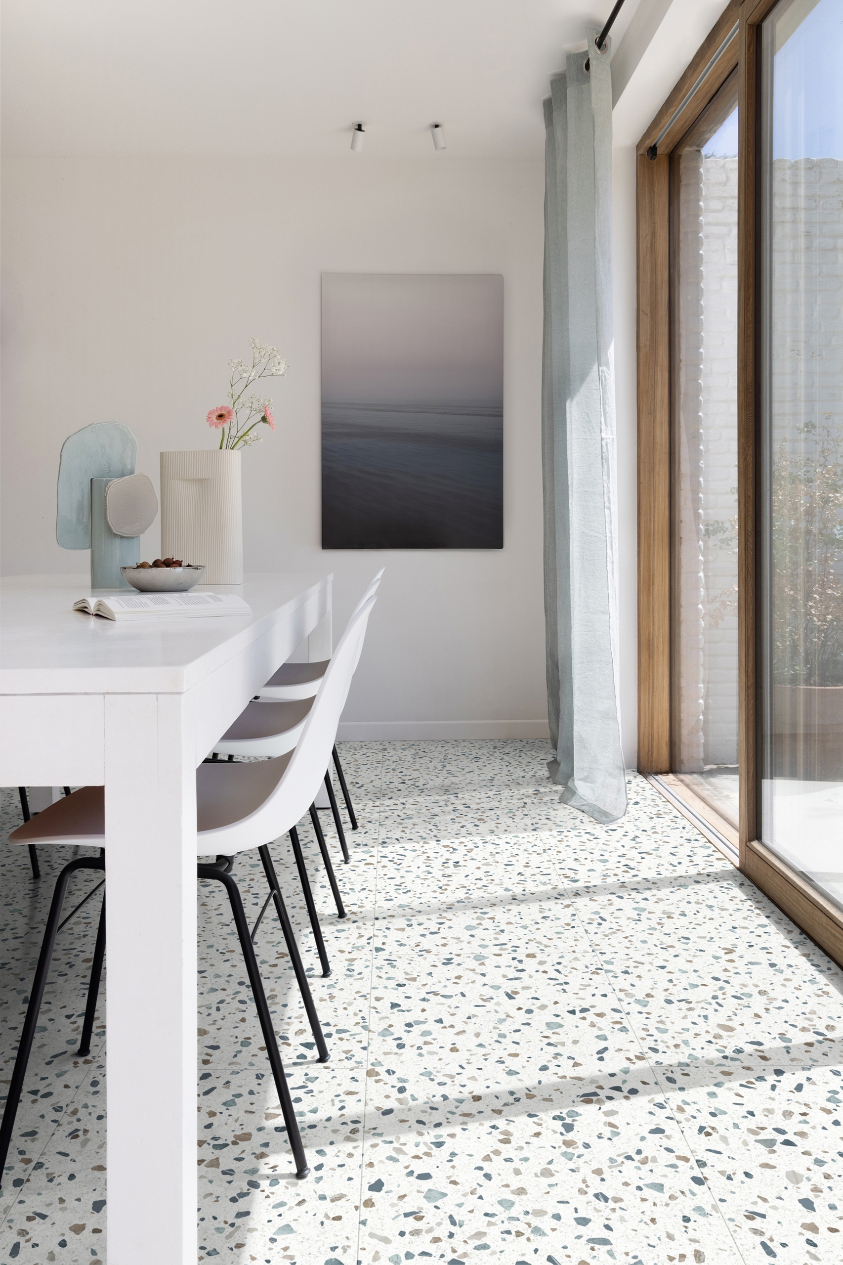 white dining room with terrazzo flooring