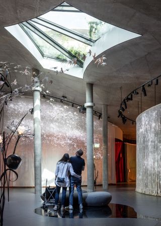 couple looking up inside the Hans Christian Andersen House by Kengo Kuma