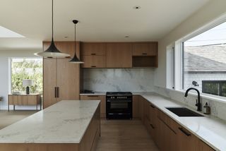 A kitchen with wooden cabinetry and floor