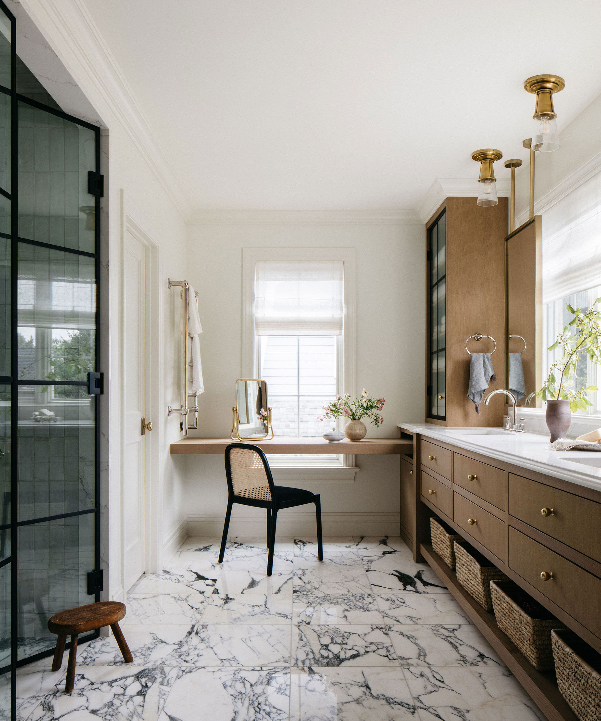 Neutral bathroom with marble floors, wooden vanity and luxury green shower tile