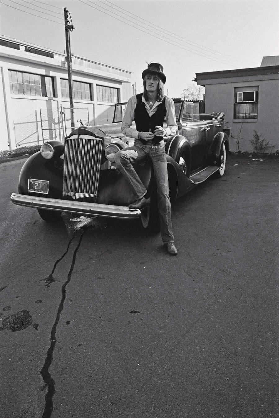 Mick Fletwood posed by a vintage car outside a recording studio in New Haven, Connecticut, USA, October 1975