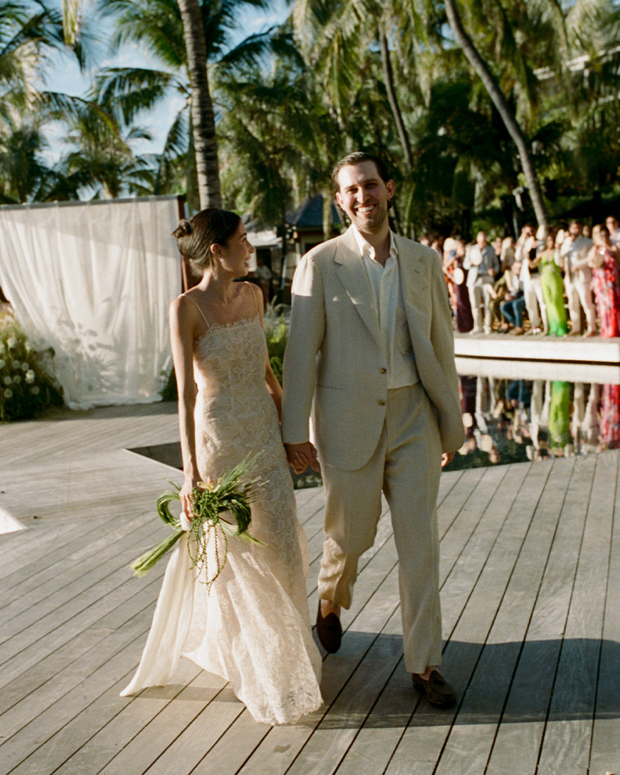 The bride and groom walk down the aisle.