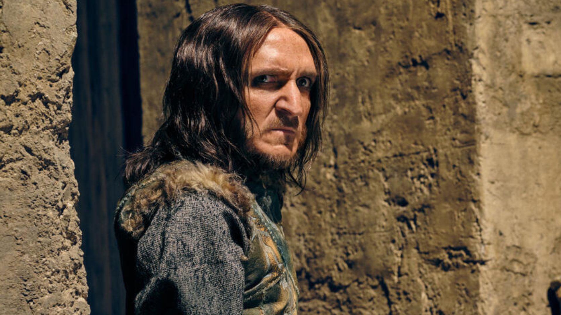 Satyrus leans against a wall