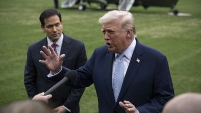 President Donald Trump talks to reporters about Iran with Secretary of State Marco Rubio watching