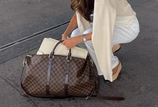 Woman wearing Louis Vuitton weekender duffel bag