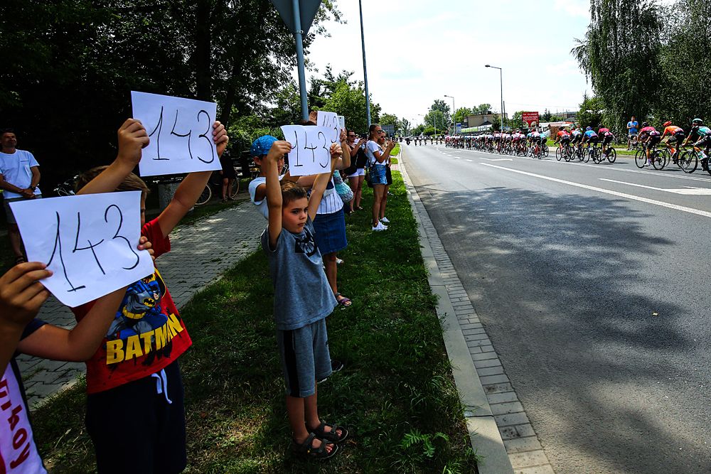 Supporters and fans wave Bjorg Lambrecht's bib no. 143 at the Tour de Pologne