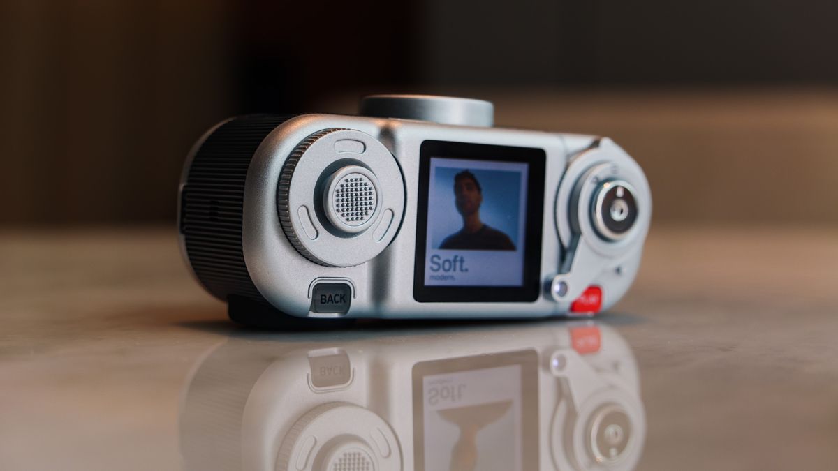 Fujifilm Instax Pal 2 digital camera on a marbled white surface, close up of the joystick