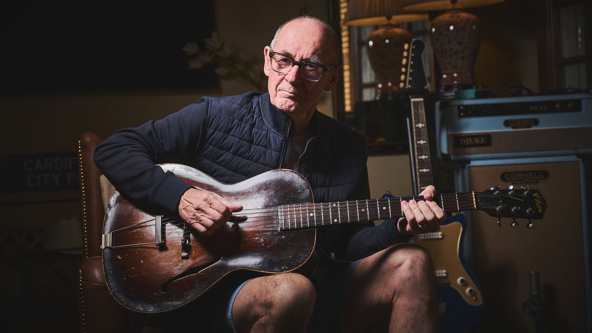 Andy Fairweather Low poses with his Gibson L-37 guitar