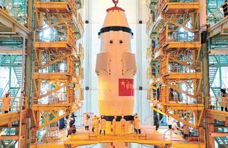 Workers prepare the Chinese Long March 2F rocket, carrying the Shenzhou 8 spacecraft, for its November 2011 launch.