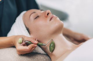 a woman having a professional lympathic draining massage on her double chin