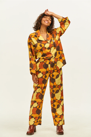 woman wearing colourful pyjama set with a 70s style overlapping circle print
