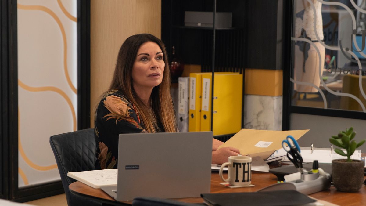 Carla Connor looks concerned as she reads an official document.