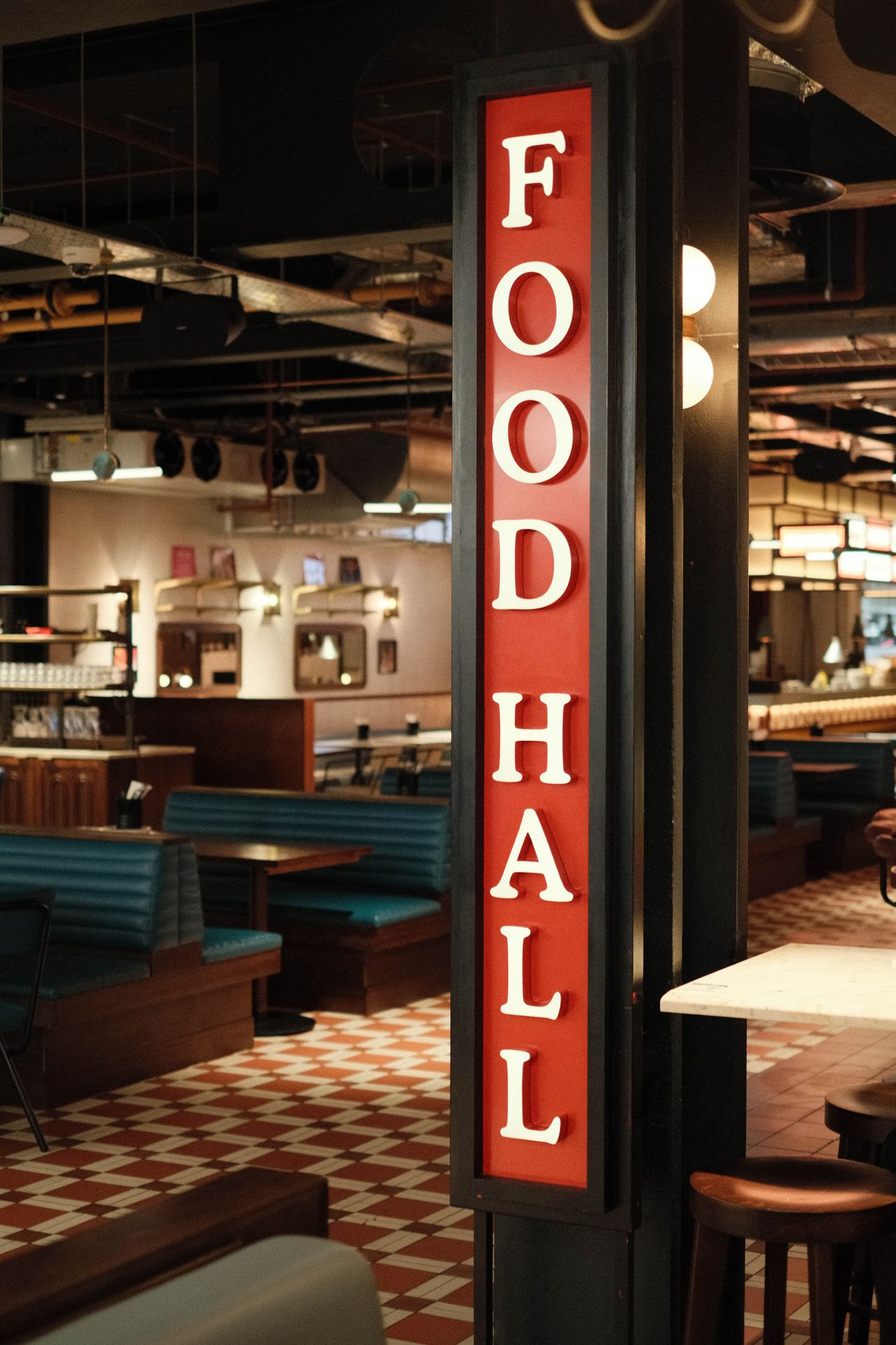 A sign saying 'food hall' in front of a vintage style diner