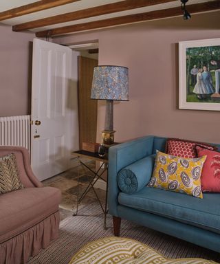 Pink living room with blue couch