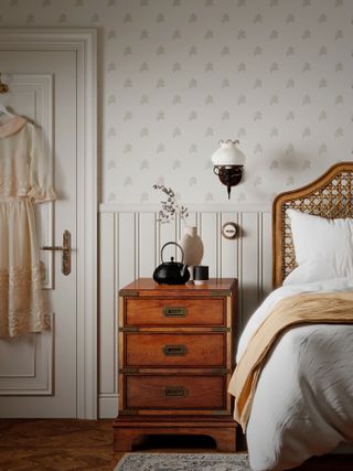 neutral bedroom with subtle wallpaper, rattan bed, vintage side table, wall light