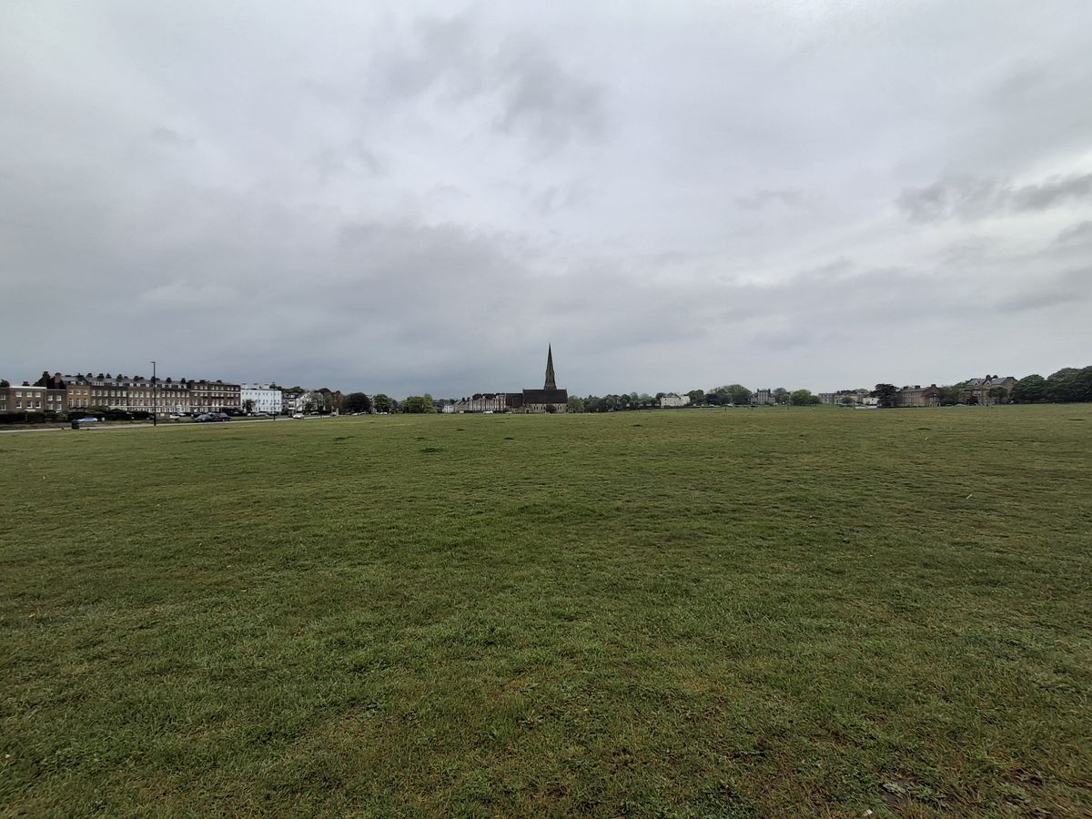 A field with a church taken on the Samsung Galaxy A35