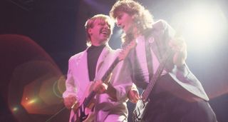 Alex Lifeson and Geddy Lee work that '80s style as they perform live with Rush in 1984.