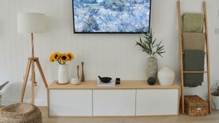 white wall-mounted unit with plywood panelling