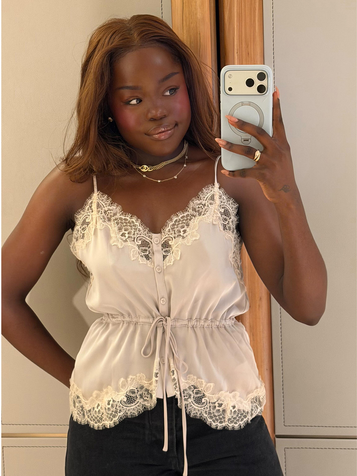 Tatenda wears a lace-trim blouse.