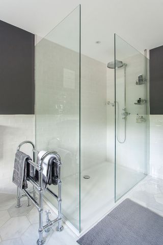 bathroom with imperial pitea towel heater and bathroom bath mat