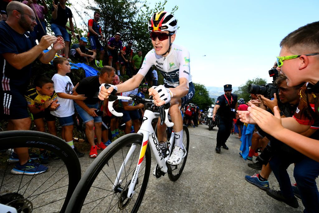 LES PRAERESNAVA SPAIN AUGUST 28 Carlos Rodriguez Cano of Spain and Team INEOS Grenadiers White Best Young Rider Jersey competes while fans cheer during the 77th Tour of Spain 2022 Stage 9 a 1714km stage from Villaviciosa to Les Praeres Nava 743m LaVuelta22 WorldTour on August 28 2022 in Les Praeres Nava Spain Photo by Tim de WaeleGetty Images