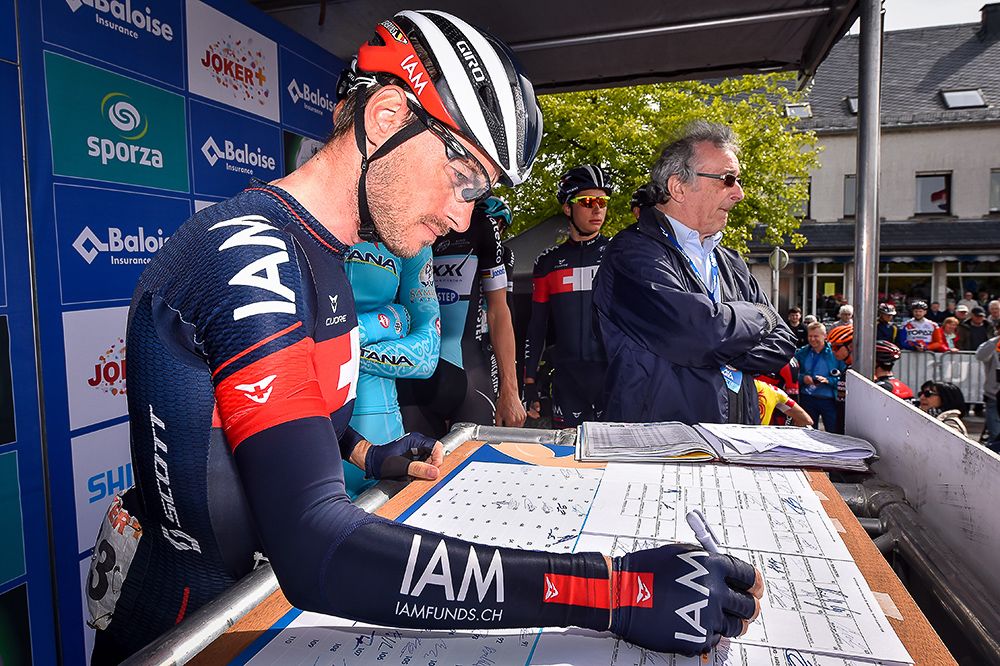 Riders sign in before the final stage in Belgium.