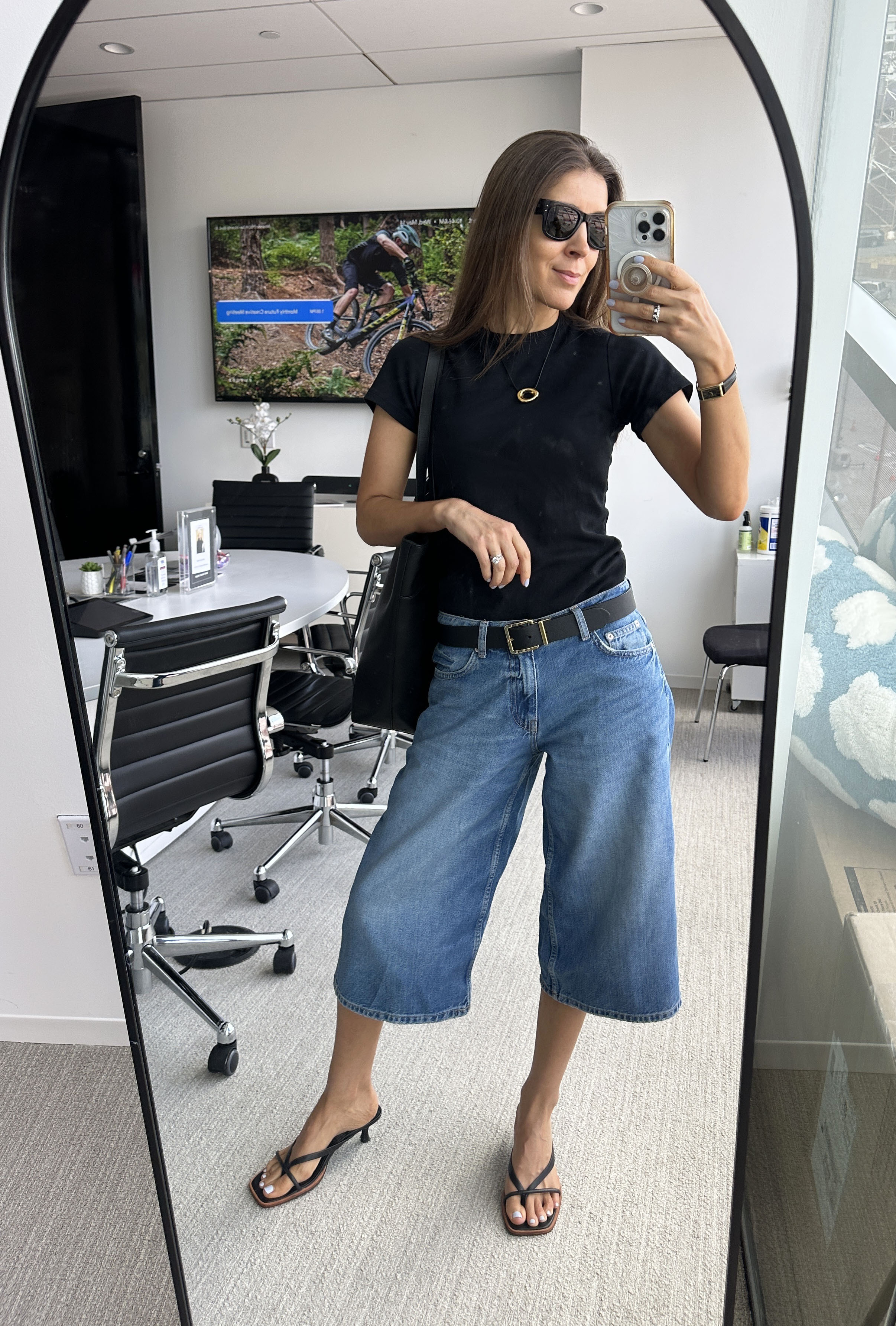 Woman in long jorts and black t-shirt
