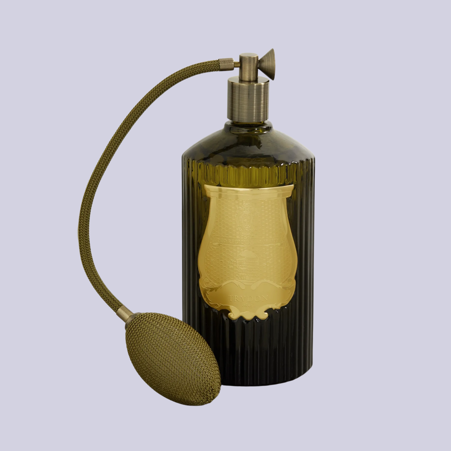 A vintage-style green glass room spray